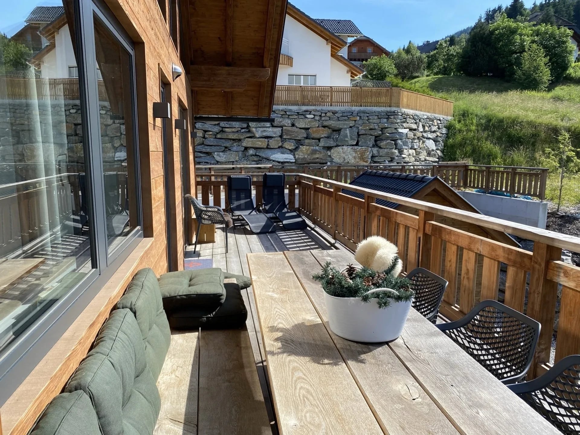 Lange Terrasse entlang der Fassade mit Tisch und Loungebereich