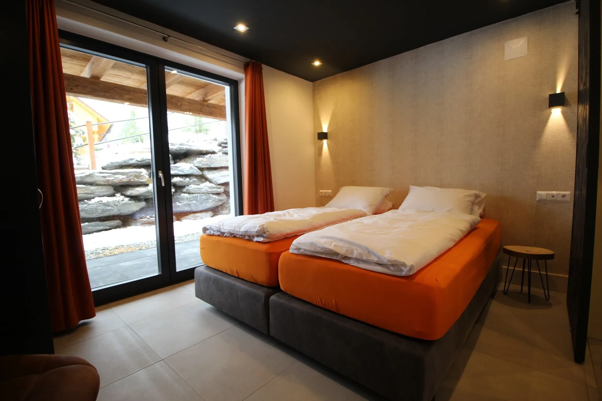 Bedroom with extra-long box-spring beds and door to the terrace