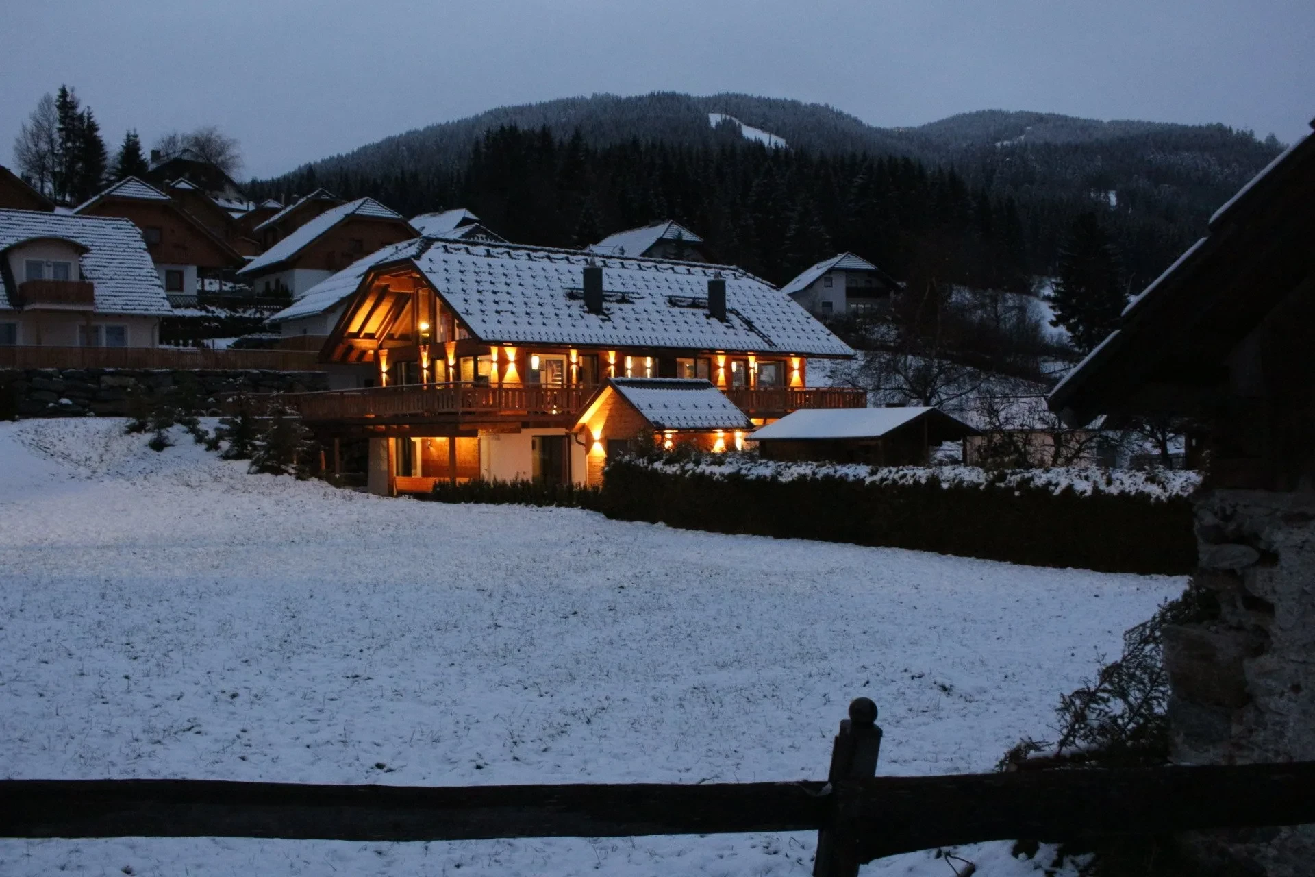 Snow-covered Sankt Margarethen with the lit chalets at dusk