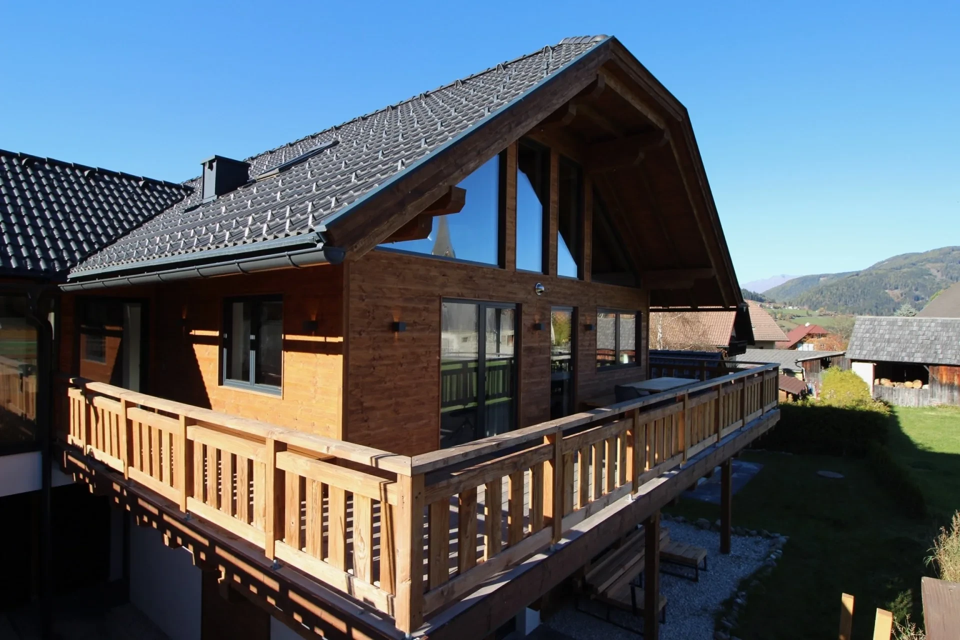 Front of the chalet with large windows and balcony