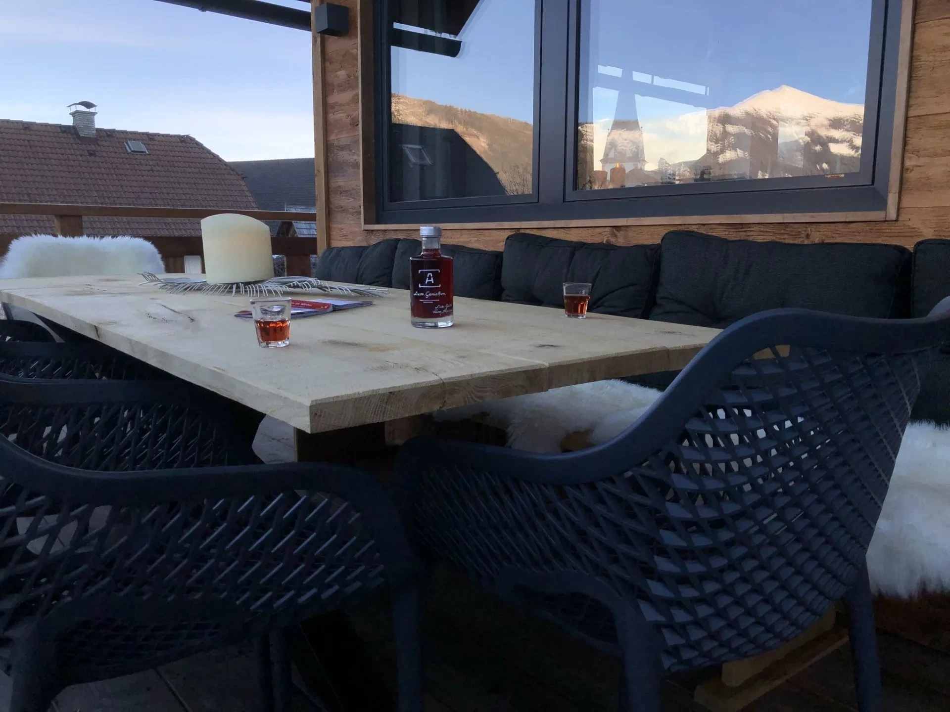 Terrace table in the winter sun with views of the snowy mountains